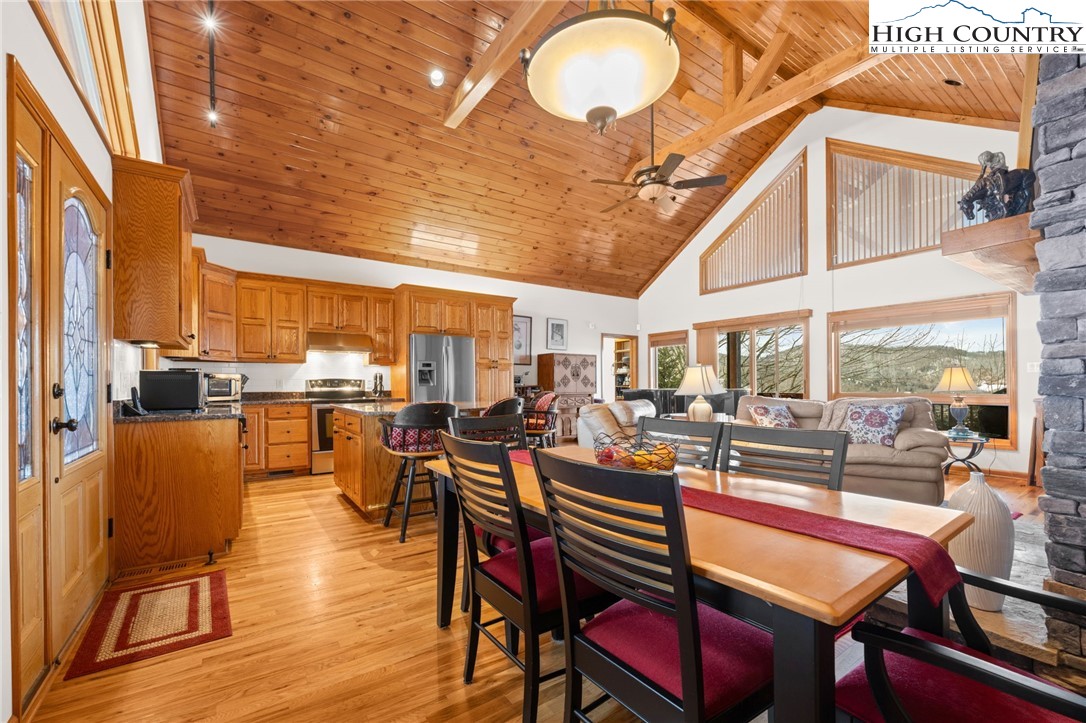 295 Supreme Golden Road Banner Elk, NC 28604 - Photo 7 of 40 a room with lots of wooden furniture and large windows