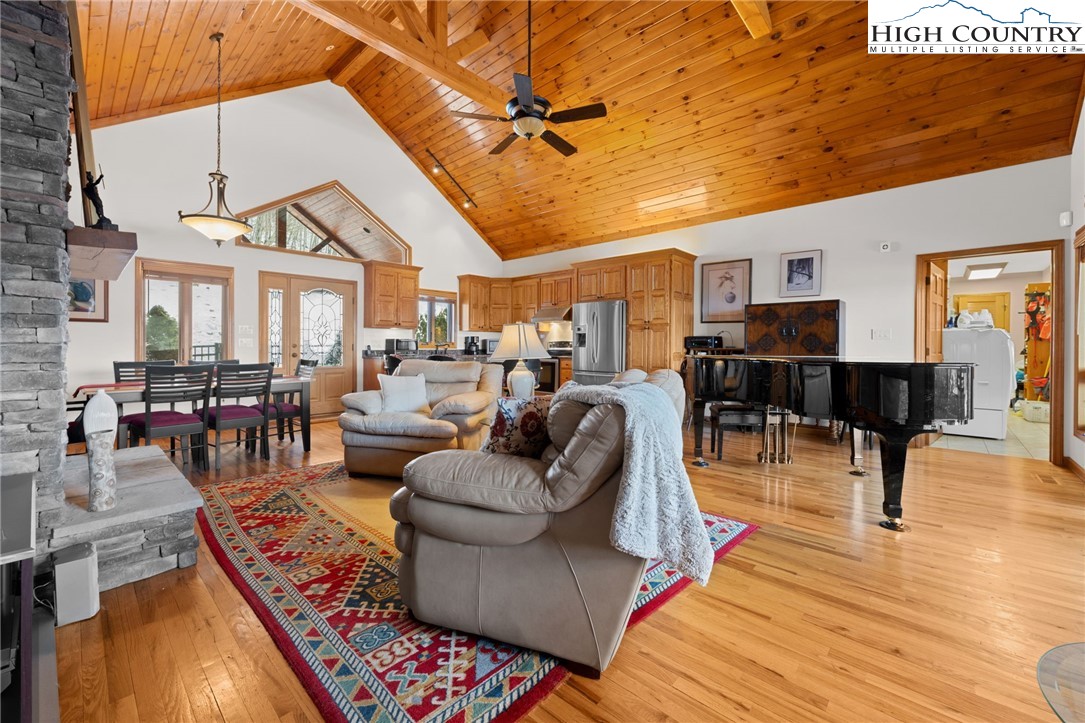 295 Supreme Golden Road Banner Elk, NC 28604 - Photo 10 of 40 a living room with furniture a rug and a chandelier