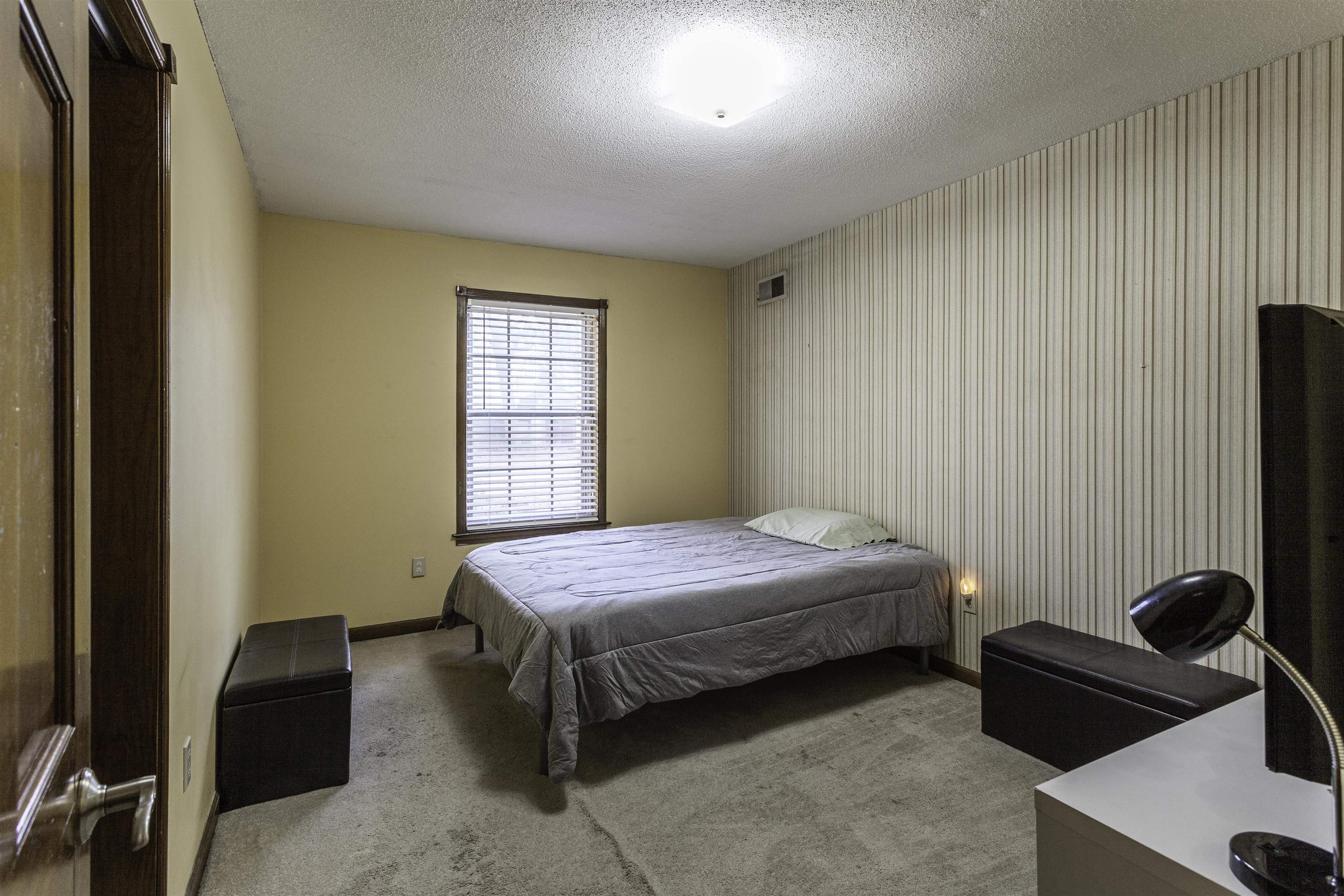 3462 Fox Meadows Road Memphis, TN 38115 - Photo 17 of 23 a bedroom with a bed and a dresser next to a window
