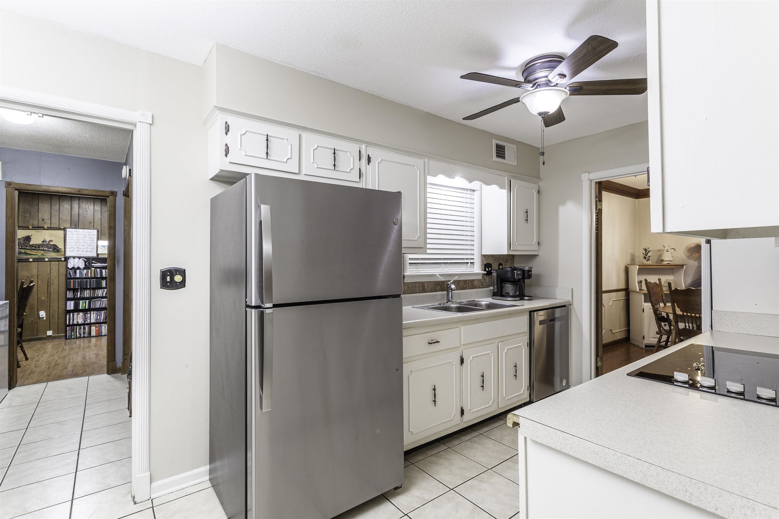 3462 Fox Meadows Road Memphis, TN 38115 - Photo 9 of 23 a kitchen with stainless steel appliances a refrigerator sink and cabinets