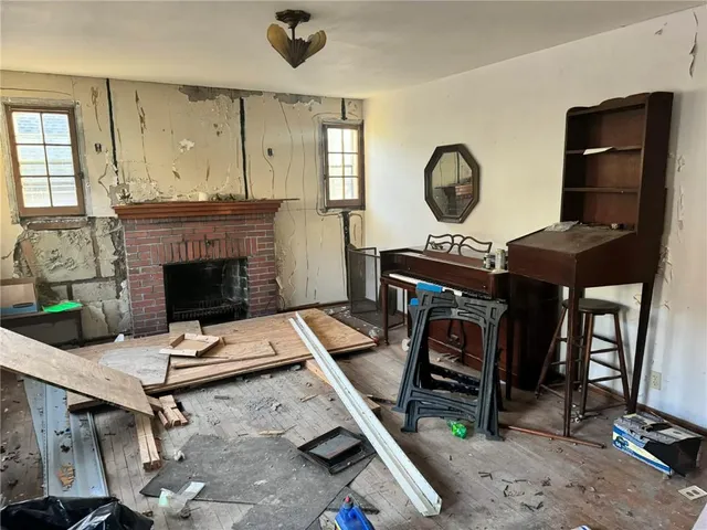 a living room with furniture a fireplace and a table