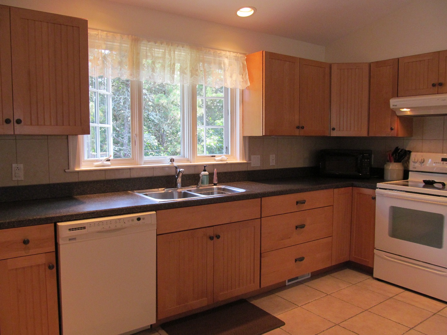 109 Herring Creek Road Edgartown, MA 02539 - Photo 8 of 16 a kitchen with granite countertop white cabinets and white appliances