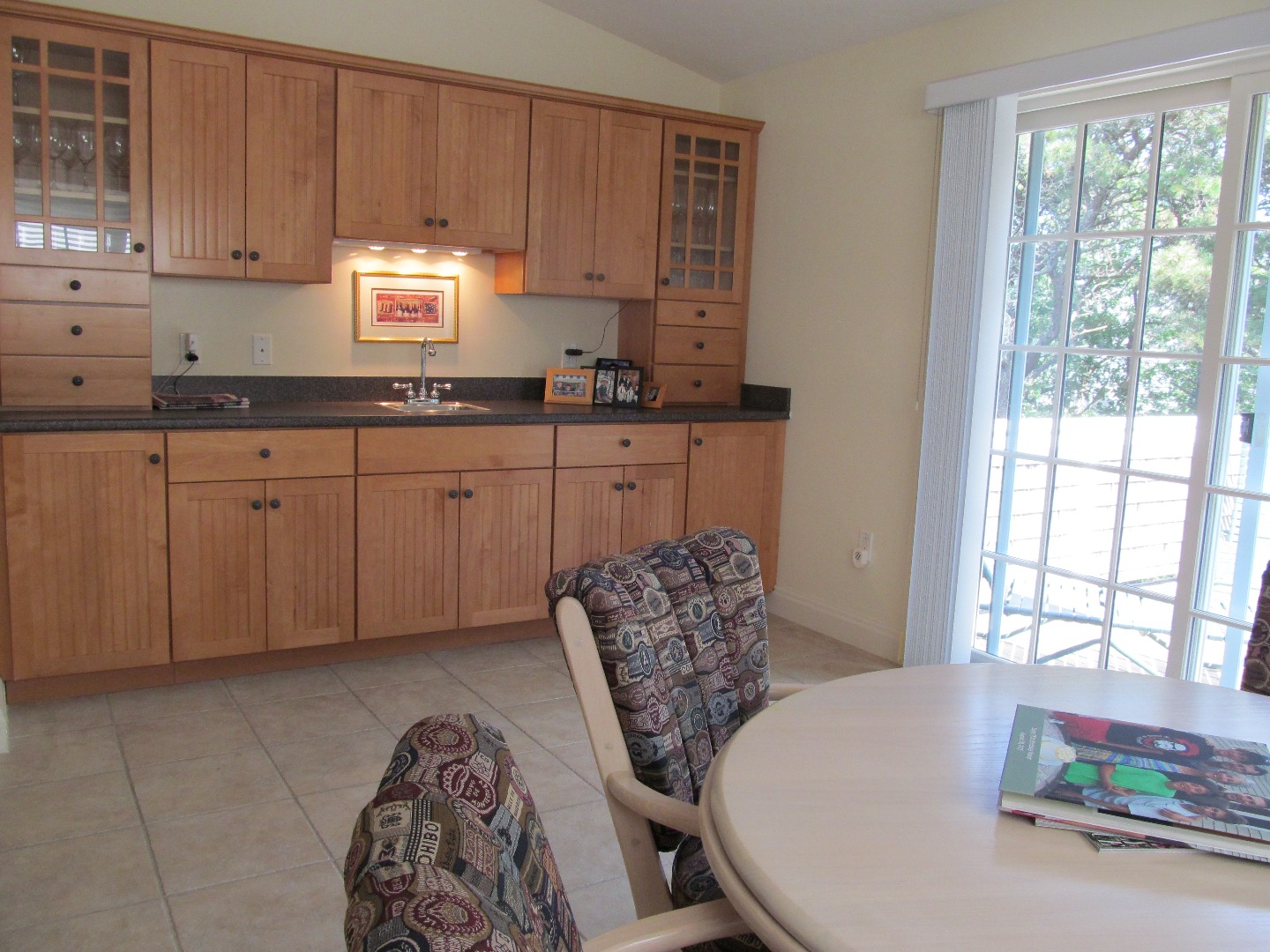 109 Herring Creek Road Edgartown, MA 02539 - Photo 9 of 16 a kitchen with stainless steel appliances granite countertop a sink a window and white cabinets