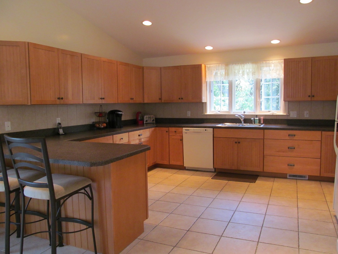 109 Herring Creek Road Edgartown, MA 02539 - Photo 10 of 16 a kitchen with stainless steel appliances granite countertop a stove a sink and a microwave
