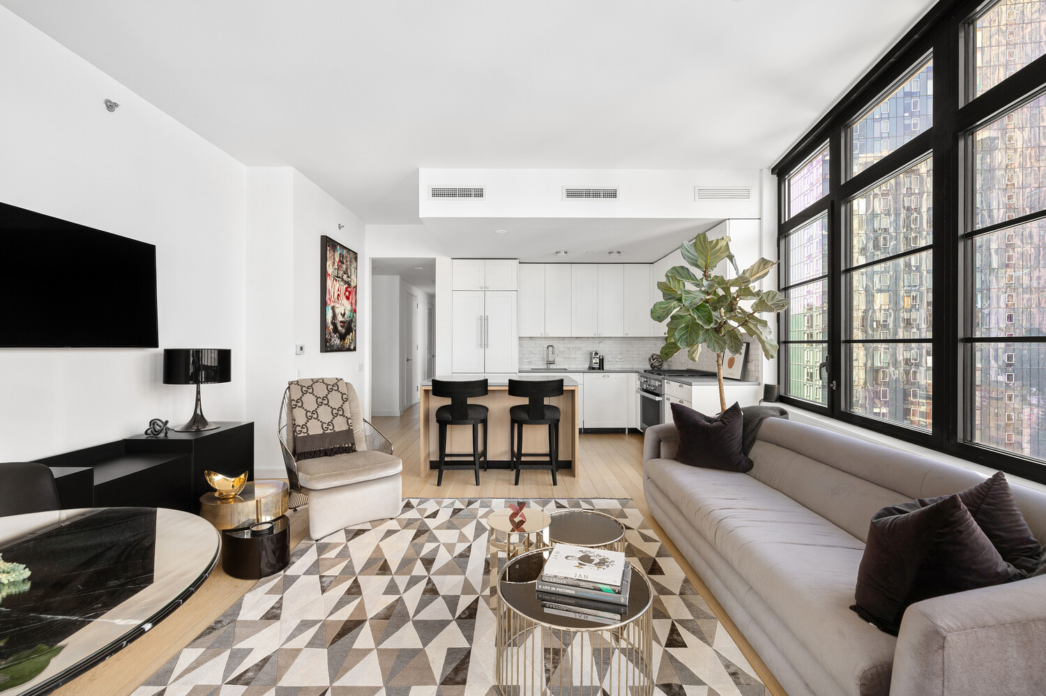 50 West 30th Street, Unit 18B Manhattan, NY 10001 - Photo 3 of 10 a living room with furniture and a flat screen tv