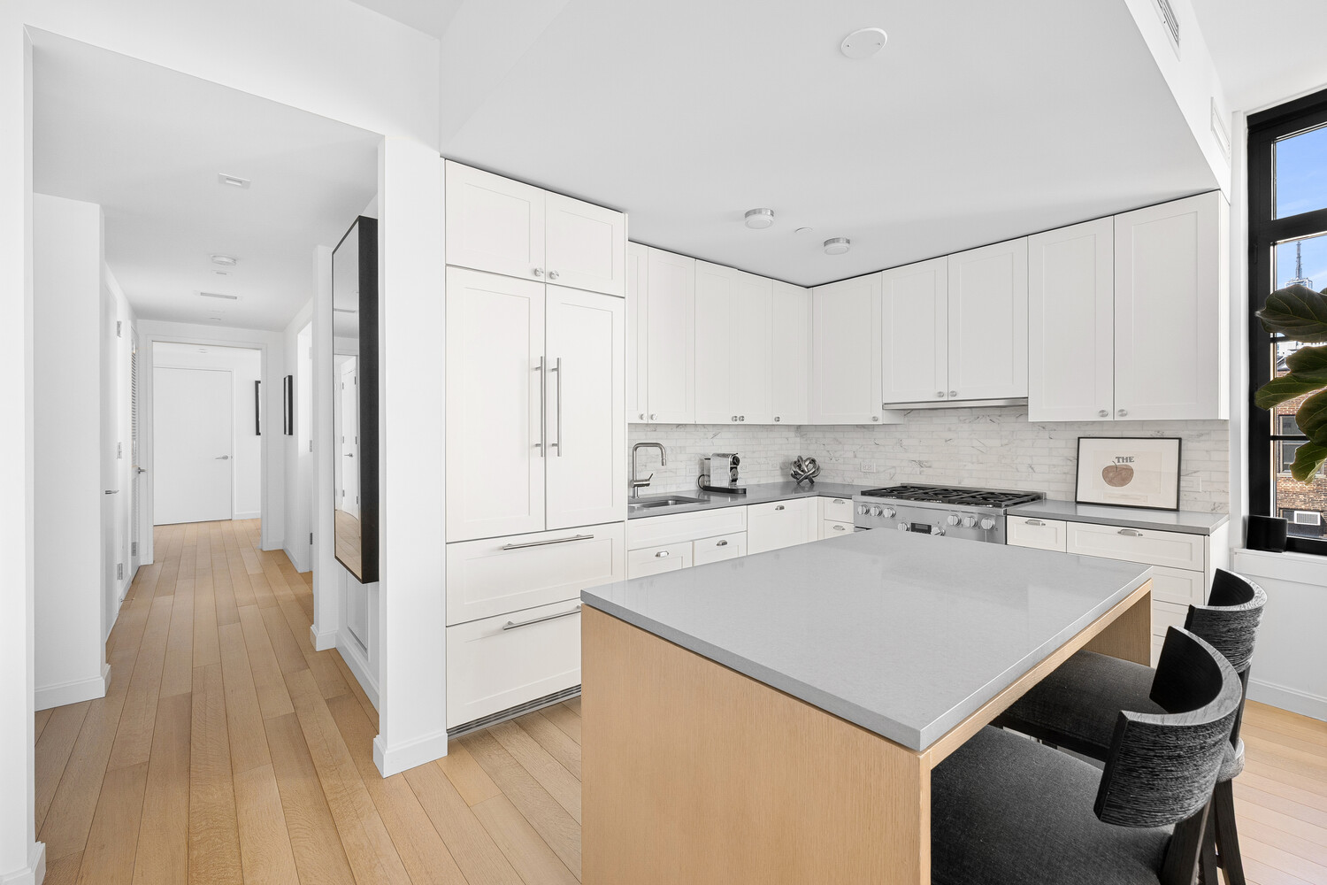 50 West 30th Street, Unit 18B Manhattan, NY 10001 - Photo 5 of 10 a kitchen with a sink a stove a refrigerator and white cabinets
