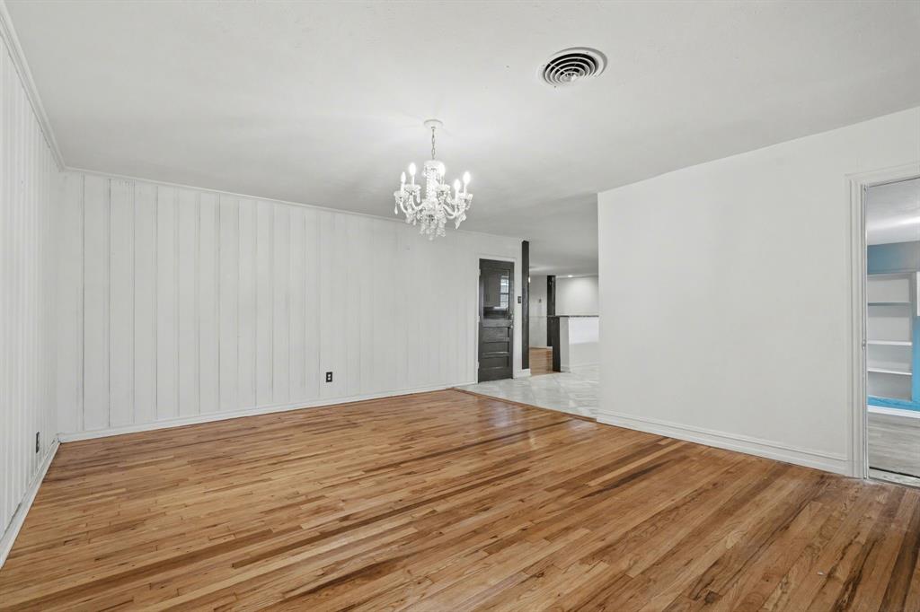 1714 East Union Bower Road Irving, TX 75061 - Photo 16 of 32 a view of a room with wooden floor and a chandelier
