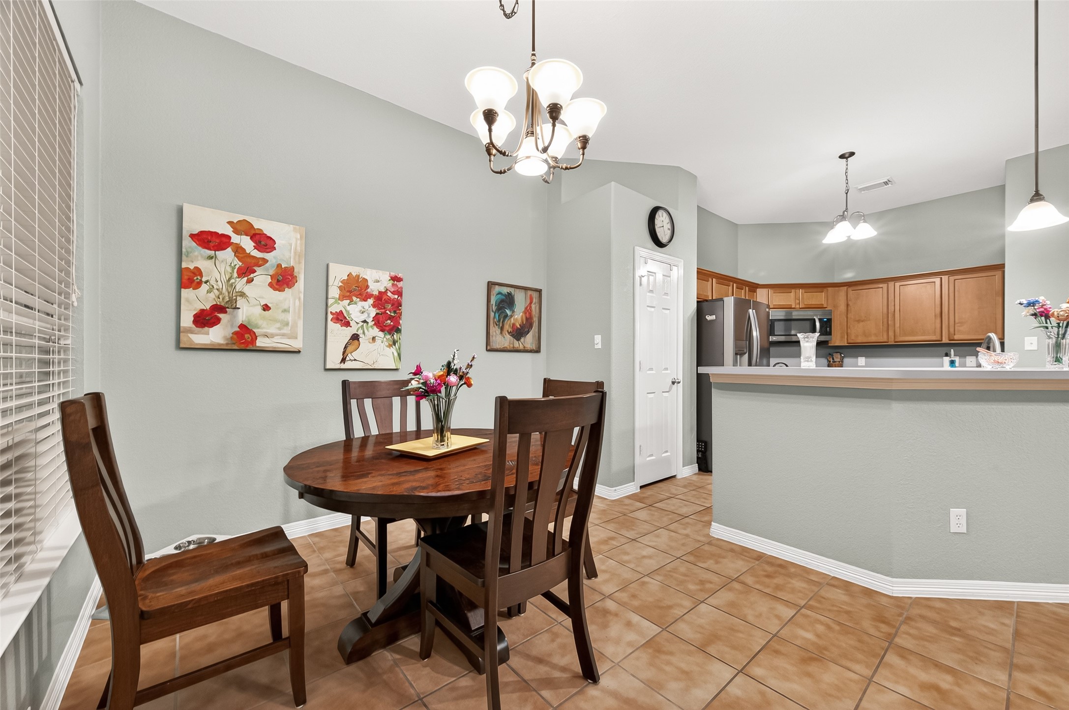 12455 West Summerlin Conroe, TX 77302 - Photo 16 of 31 a view of a dining room with furniture and a chandelier