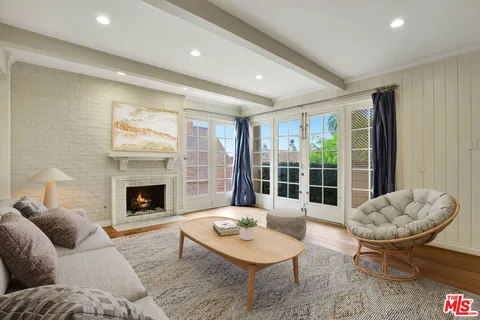 a living room with furniture a table and a fireplace