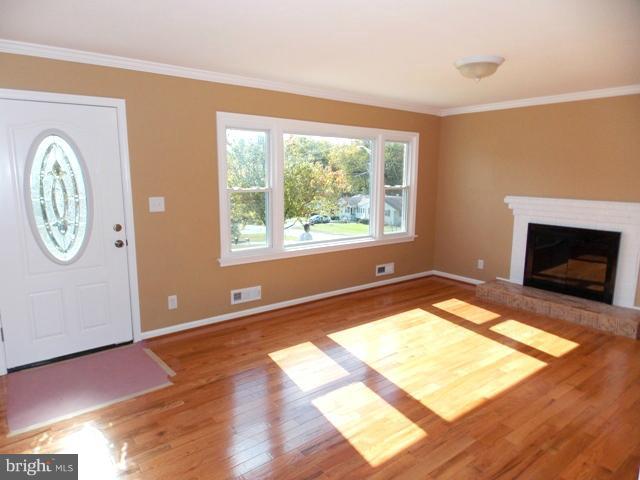 2402 Roth Road Edgewood, MD 21040 - Photo 15 of 27 a view of an empty room with window wooden floor and a kitchen