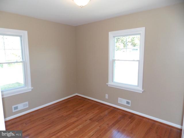 2402 Roth Road Edgewood, MD 21040 - Photo 18 of 27 an empty room with wooden floor and a window