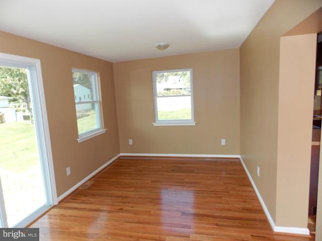 2402 Roth Road Edgewood, MD 21040 - Photo 7 of 27 a view of an empty room with wooden floor and a window