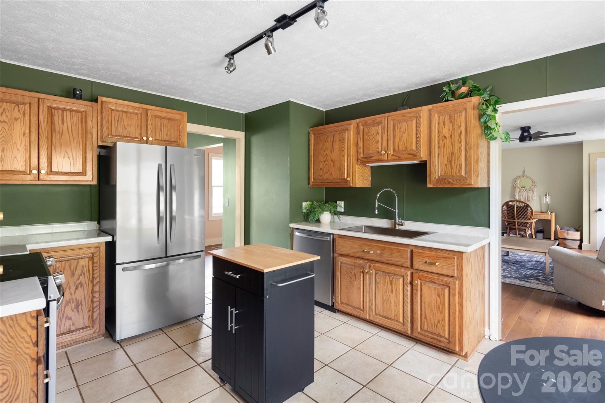 17 Boyd Cove Road Leicester, NC 28748 - Photo 13 of 40 a kitchen with stainless steel appliances granite countertop a refrigerator a sink dishwasher a stove with white cabinets and wooden floor