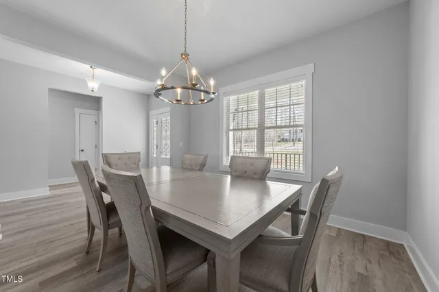 a bedroom with a bed a window and a flat screen television