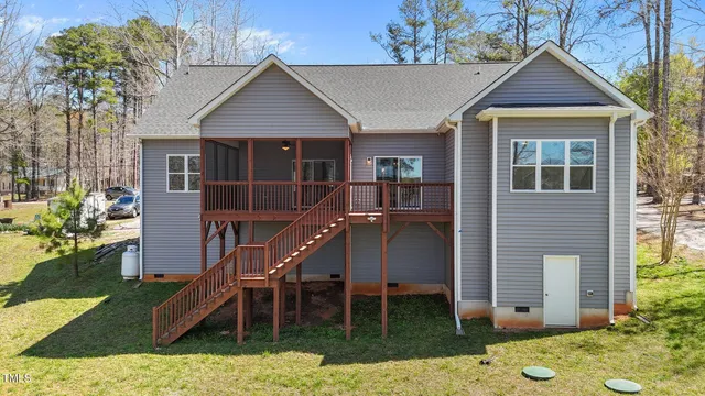 an aerial view of a house with a yard
