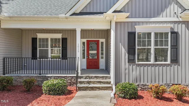a living room with furniture kitchen view and a chandelier