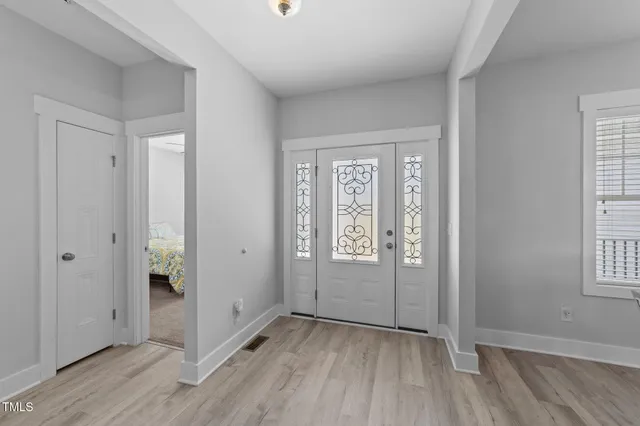 a kitchen with stainless steel appliances a stove a sink a refrigerator and a dining table