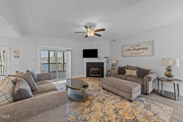 a kitchen with stainless steel appliances kitchen island granite countertop a table chairs sink and cabinets