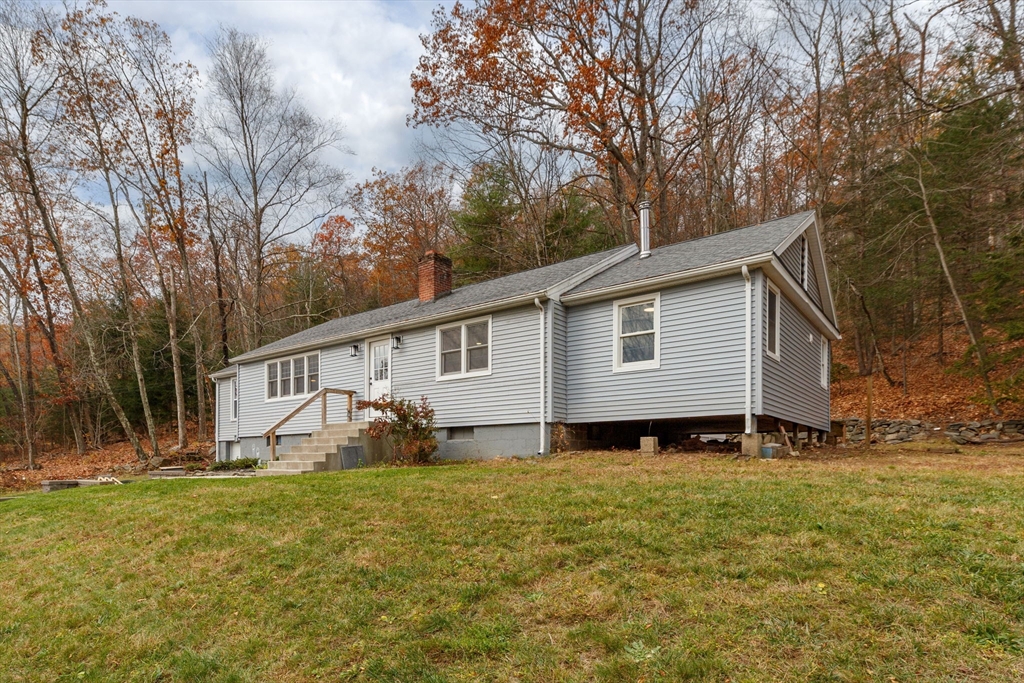 143 James Street Ludlow, MA 01056 - Photo 2 of 41 a view of a small house in a big yard with large trees