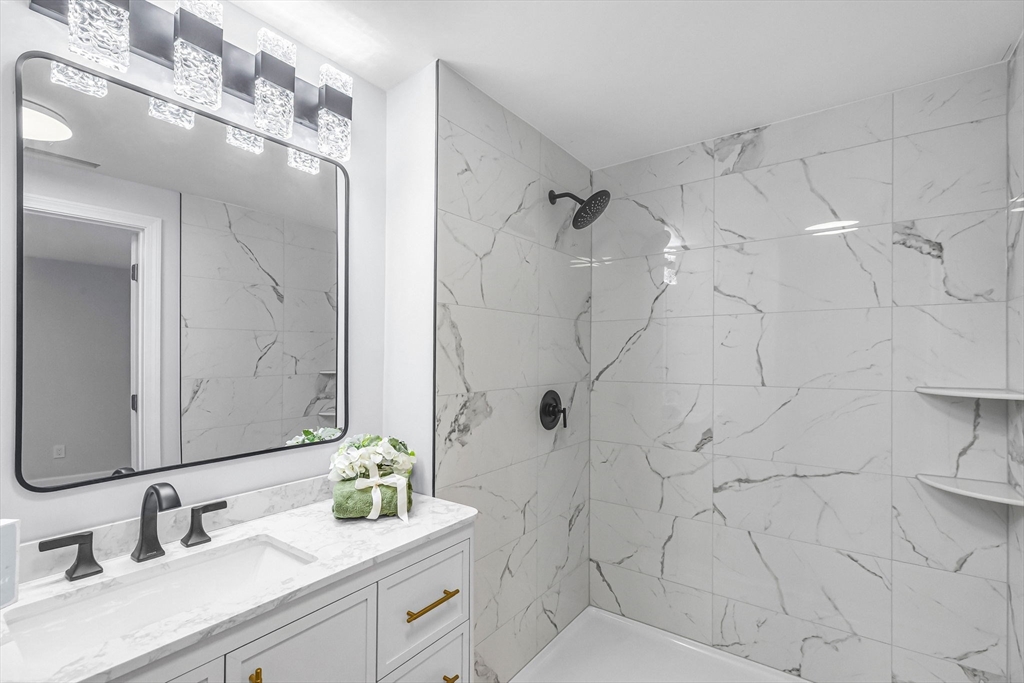 143 James Street Ludlow, MA 01056 - Photo 29 of 41 a bathroom with a double vanity sink mirror and shower