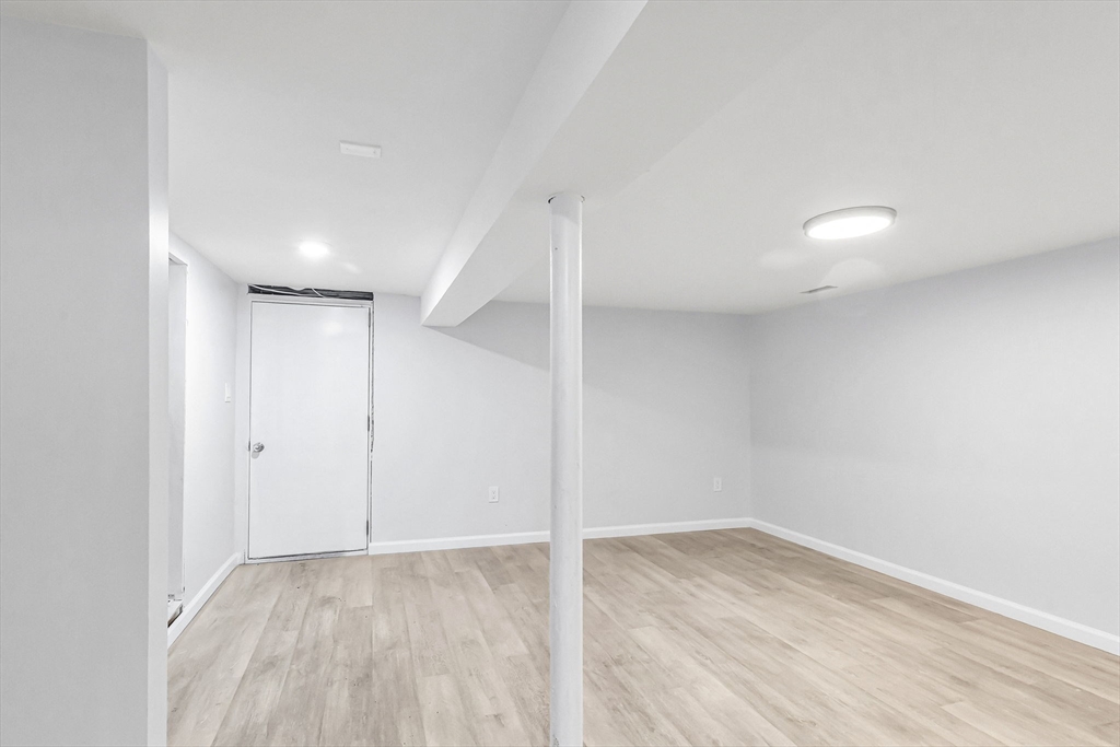 143 James Street Ludlow, MA 01056 - Photo 34 of 41 an empty room with wooden floor and windows