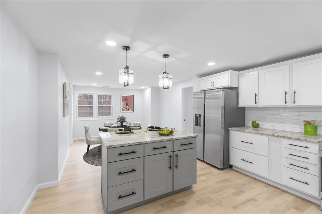 143 James Street Ludlow, MA 01056 - Photo 41 of 41 a kitchen with a refrigerator a sink dishwasher a stove and white cabinets with wooden floor
