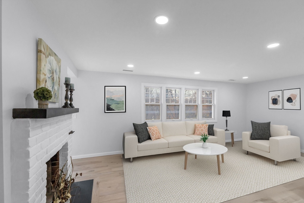 143 James Street Ludlow, MA 01056 - Photo 5 of 41 a living room with furniture a fireplace and a table