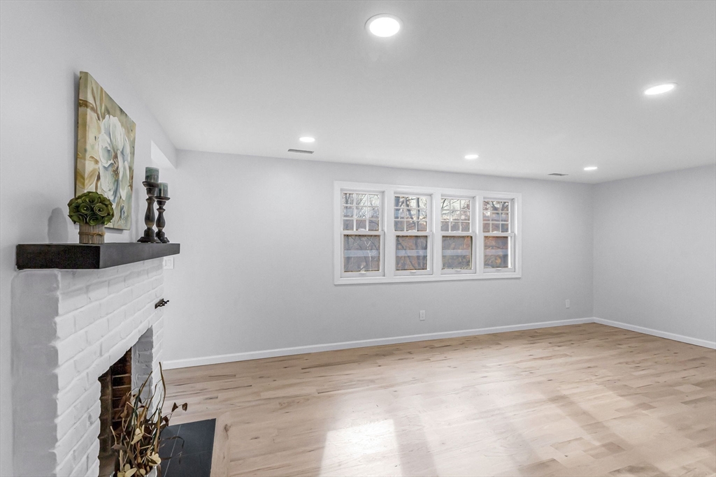 143 James Street Ludlow, MA 01056 - Photo 6 of 41 a view of an empty room with a fireplace and a window