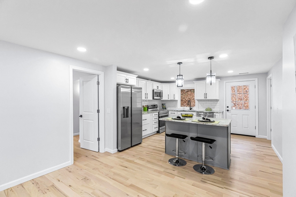 143 James Street Ludlow, MA 01056 - Photo 9 of 41 a view of a kitchen with kitchen island and stainless steel appliances