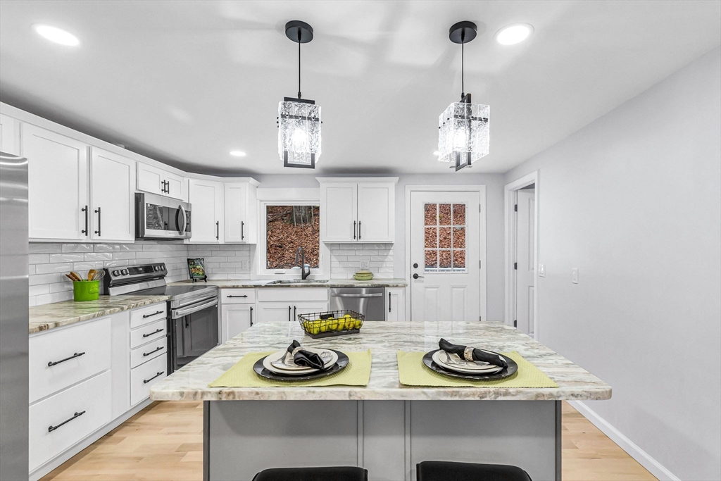 143 James Street Ludlow, MA 01056 - Photo 10 of 41 a kitchen with a sink stove and cabinets
