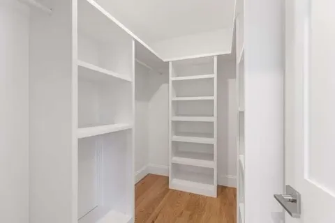 a view of walk in closet with empty racks