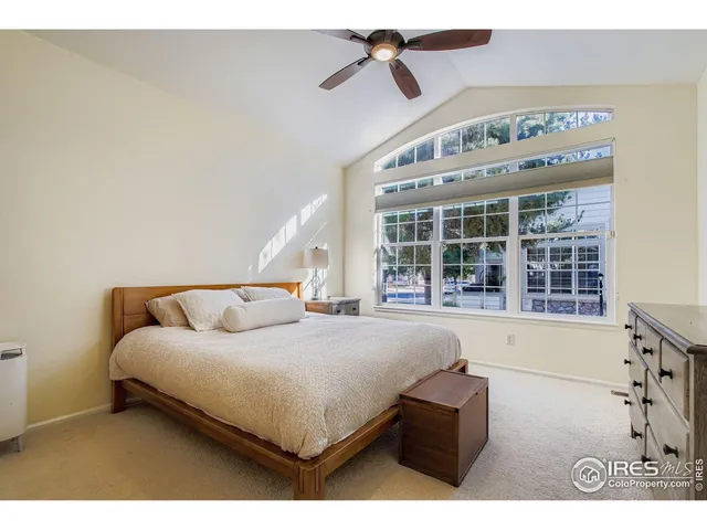 a bedroom with a large bed and a window