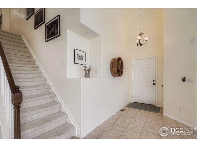 a view of a livingroom with wooden floor and stairs