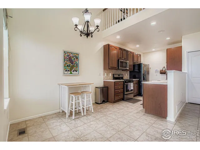 a kitchen with kitchen island appliances cabinets and furniture