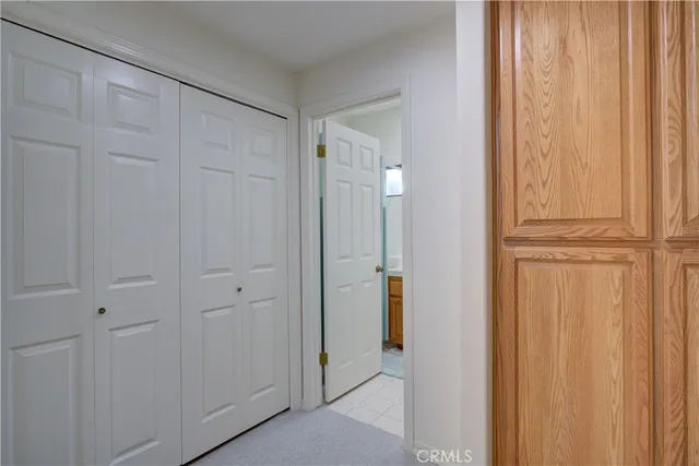 a bedroom with a large bed and a flat screen tv on dresser