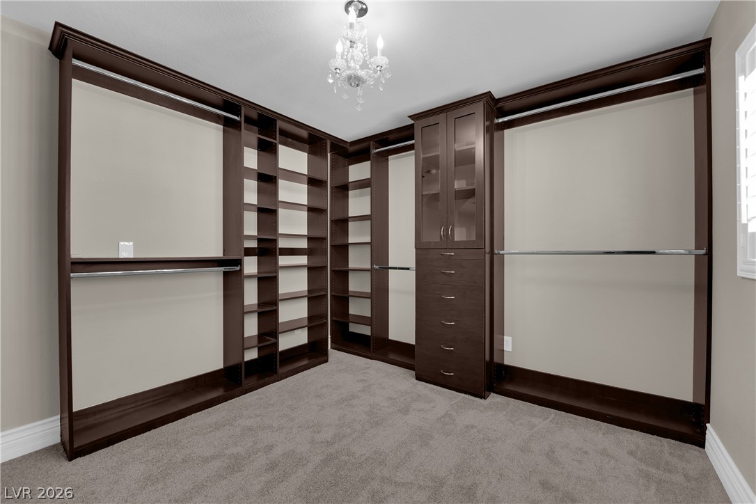 646 Monument Point Street Henderson, NV 89002 - Photo 24 of 44 Ample shelving and hanging space defines this highly functional, custom-built walk-in closet.
