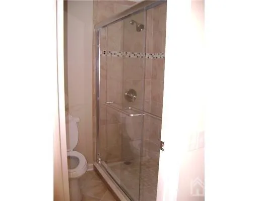 a bathroom with a granite countertop shower