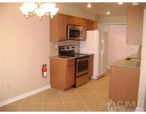 a kitchen with a stove a microwave and refrigerator