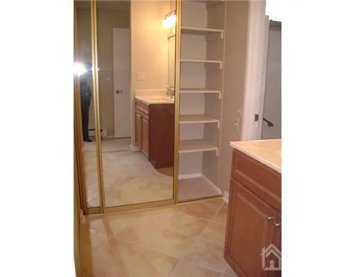 a view of walk in closet with clothes