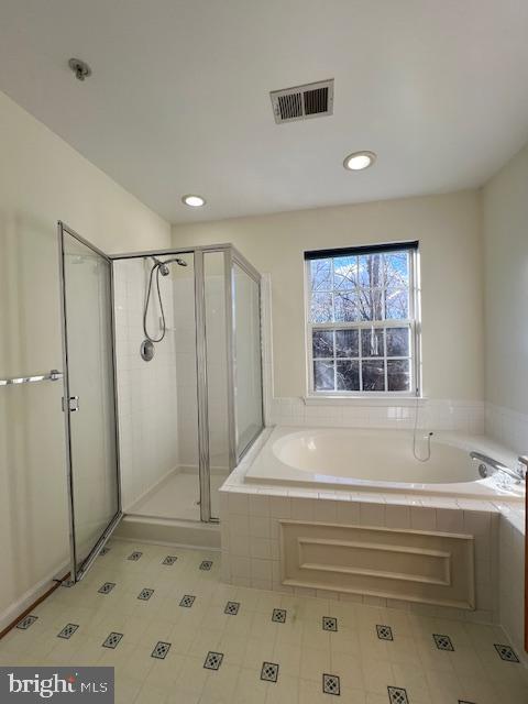 18704 Harmony Woods Lane Germantown, MD 20874 - Photo 15 of 21 a bathroom with a bathtub and a shower