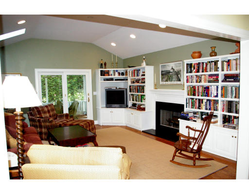 69 Bonwood Road Needham, MA 02492 - Photo 6 of 15 a living room with furniture a fireplace and a flat screen tv