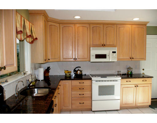 69 Bonwood Road Needham, MA 02492 - Photo 8 of 15 a kitchen with white cabinets and white appliances
