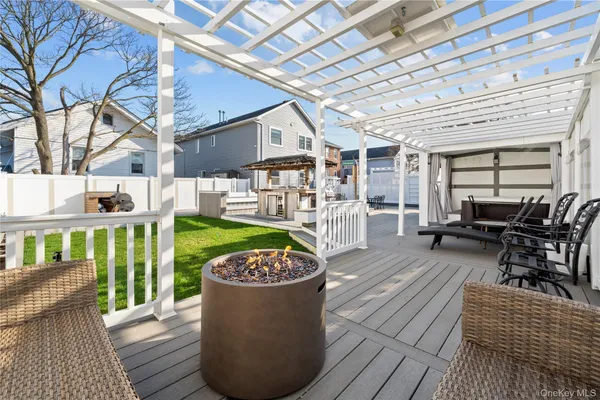 a view of a chairs and table in backyard of the house