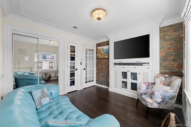 a living room with furniture a flat screen tv and a fireplace