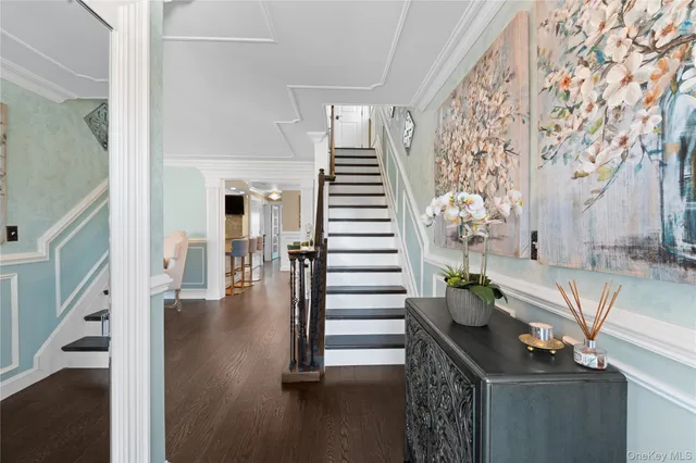 a view of entryway and hall with wooden floor