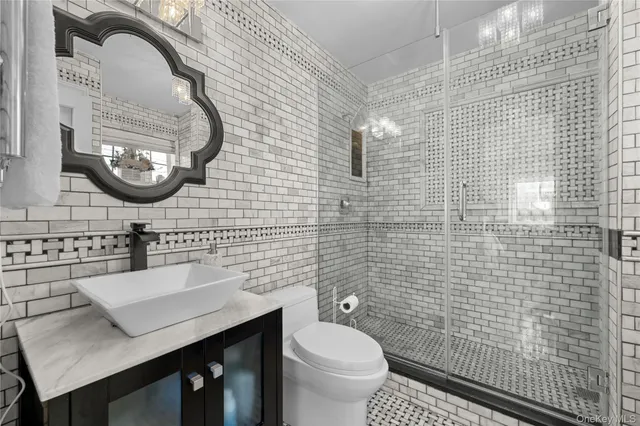 a bathroom with a sink a toilet and a mirror