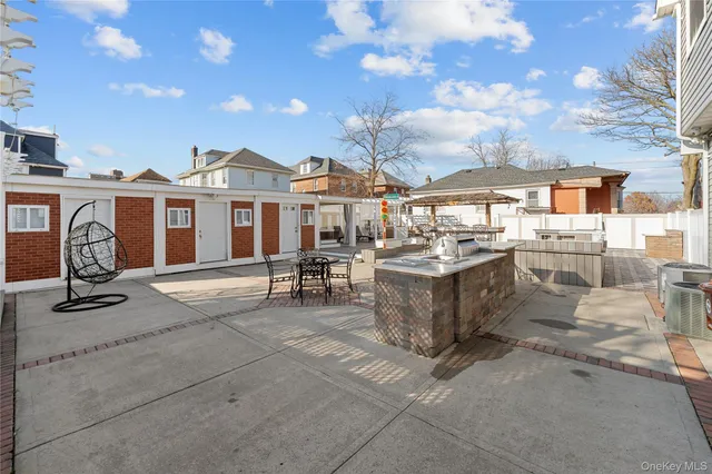 a view of a patio with dining table and chairs