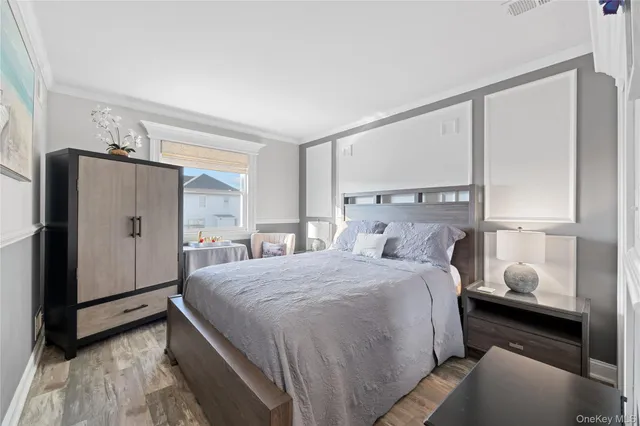 a bedroom with a bed mirror and a window