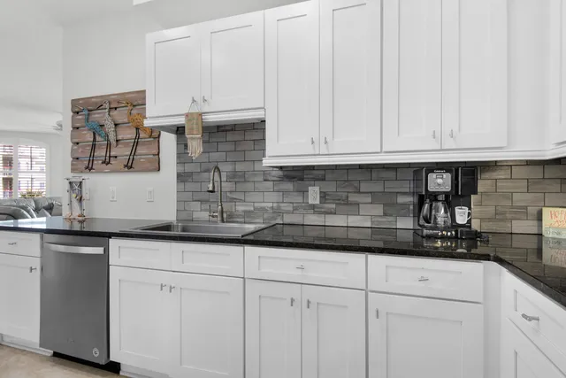 a kitchen with white cabinets and a sink