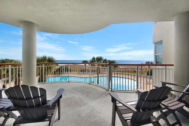 a balcony with table and chairs